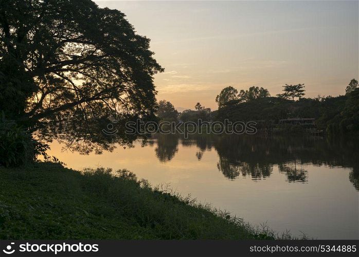 Silhouette of trees at riverside at sunset, Chiang Rai, Thailand