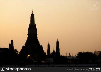 Silhouette of Wat Arun. In the evening. The orange light of the sun light.