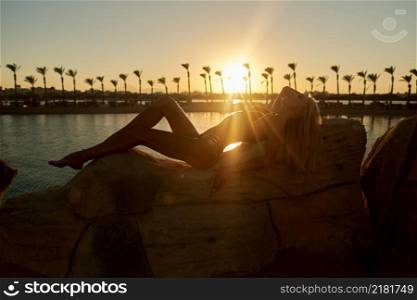 silhouette of woman at sunset seaside beach.. silhouette of woman at sunset seaside beach