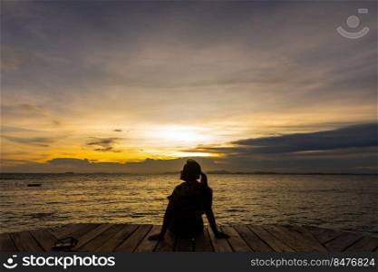 silhouette of woman jumping on the sea at sunset. soft focus and low key