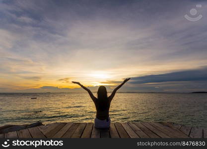 silhouette of woman jumping on the sea at sunset. soft focus and low key