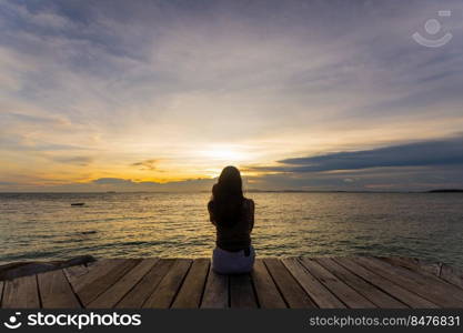 silhouette of woman jumping on the sea at sunset. soft focus and low key