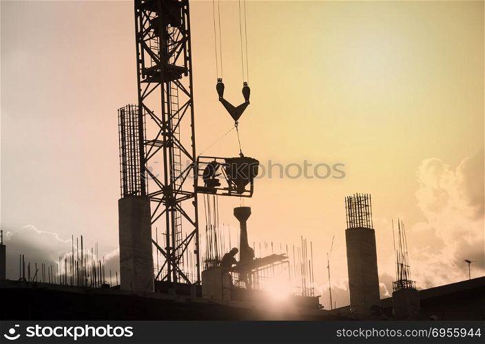 silhouette of worker working with crane for constuction building. Construction with crane