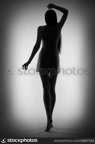 Silhouette of young girl on gray background (black and white)