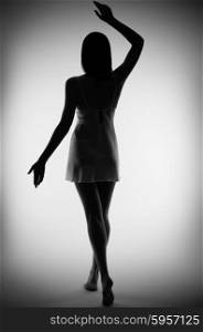 Silhouette of young girl on gray background (monochrome)