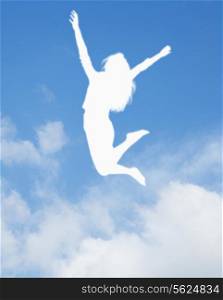 Silhouette of young woman jumping and cheering, arms in the air
