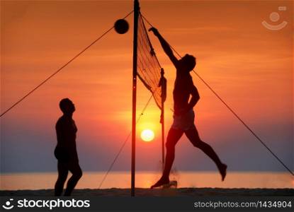 silhouette play beach volleyball. Sunset time