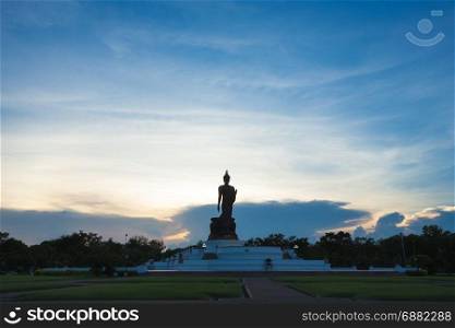 Silhouette public buddha in sunset. evening sky in sunset.