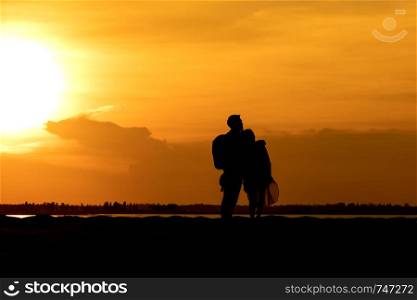 Silhouette traveler couples on mountain at sunset times. Silhouette traveler couples