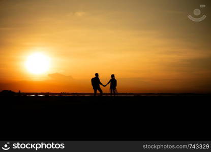 Silhouette traveler couples walking on mountain at sunset times. Silhouette traveler couples walking