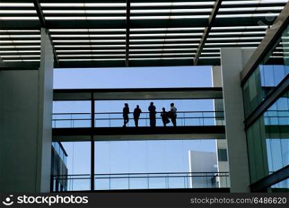 Silhouette view of some people in a modern office building interior with panoramic windows.. office building