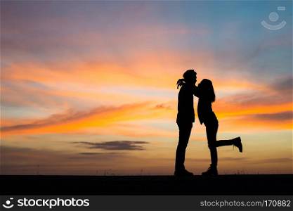 Silhouette young couple in love enjoy good time together during . Silhouette young couple in love enjoy good time together during sunset.