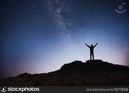Silhouette young man background of the Milky Way galaxy on a bright star dark sky tone.. Silhouette young man background of the Milky Way galaxy on a bright star dark sky tone