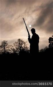silhouetted hunter with gun