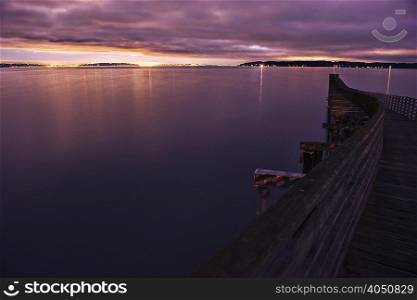 Silhouetted view of winding wooden pier over Puget Sound at night, Seattle, Washington State, USA