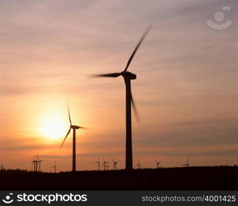 Silhouetted wind turbines