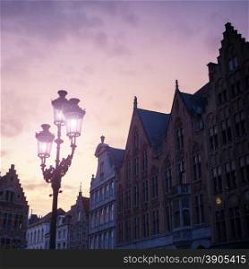 Silhouettes of city center houses in Bruges against beautiful sunset, Belgium