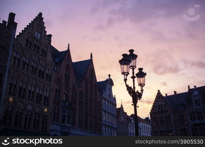 Silhouettes of city center houses in Bruges against beautiful sunset, Belgium