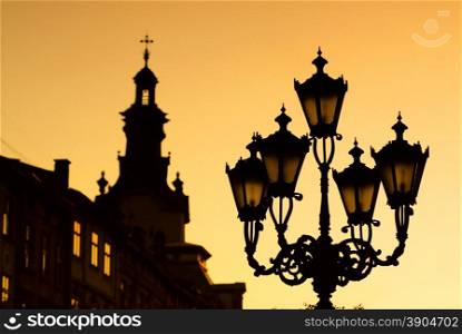 silhouettes of city lantern on the sunset