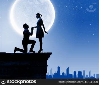 Silhouettes of man making proposal to woman