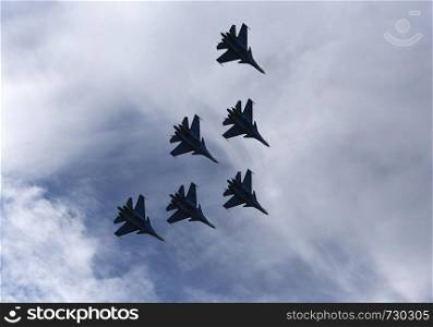 Silhouettes of russian fighter aircrafts in the sky. Russia, Moscow Airshow in July 2017
