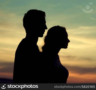 Silhouettes of the young calm couple