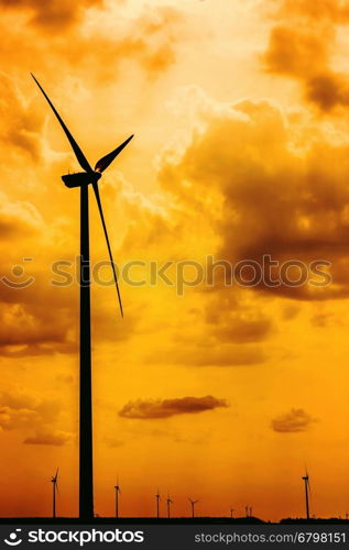 Silhouettes Of Wind Turbines Converting Wind Energy To Electricity