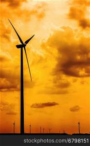 Silhouettes Of Wind Turbines Converting Wind Energy To Electricity