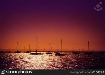 Silhouettes of yachts in the sea at sunset, La Paz, Mexico
