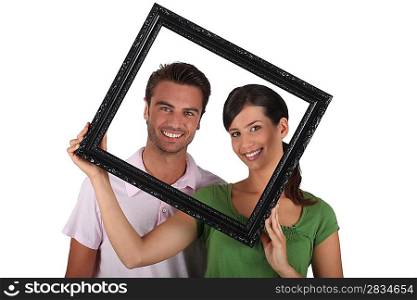 Silly couple with picture frame