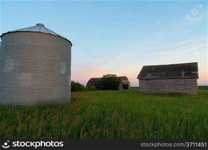 Silo and barn in a prairie field, Manitoba, Canada