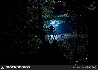 Siluette of man in the forest on the night