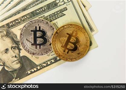 Silver and gold bitcoin coins with dollars on the white background. Bitcoin coin with dollars