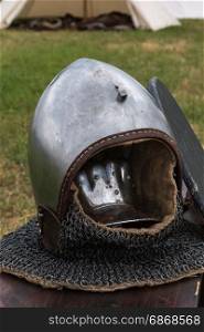 Silver and Metallic Knight Helmet on Wooden Table, Medieval Theme