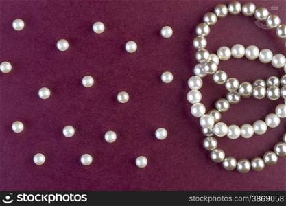 Silver and White pearls necklace on dark red background
