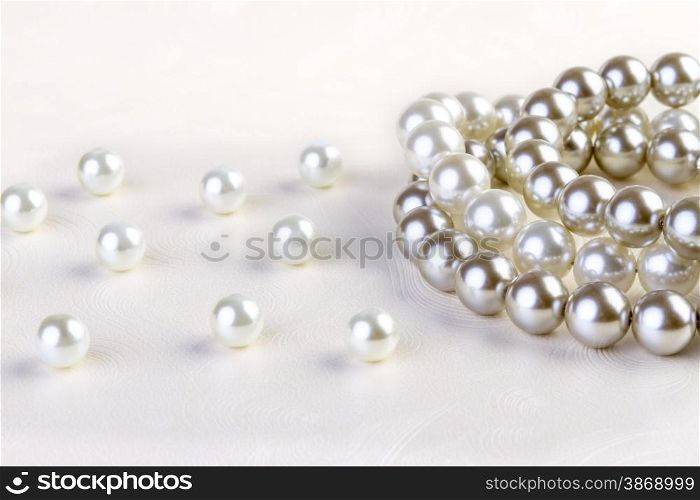 Silver and White pearls necklace on white paper background&#xA;