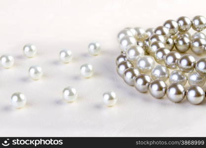 Silver and White pearls necklace on white paper background&#xA;