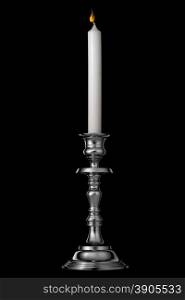Silver candlestick with candle isolated on black