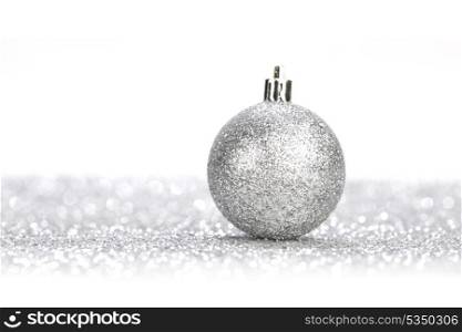 Silver christmas ball on glitter background with white copy space