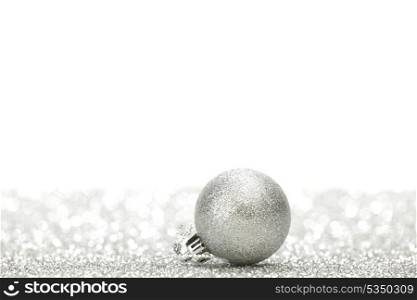Silver christmas ball on glitter background with white copy space
