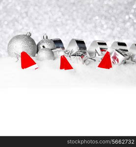 Silver Christmas decorations on snow close-up