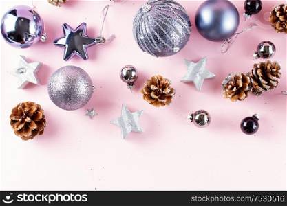 Silver Christmas decorations with gift box on pink background border. Gray Christmas decorations on pink