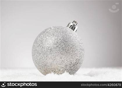 silver christmas decorative ball on snow