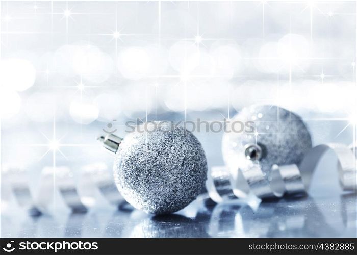 Silver christmas decorative balls on shiny stars background