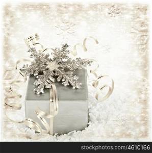 Silver Christmas gift background with ribbons and shiny snowflake, winter holiday silver present box