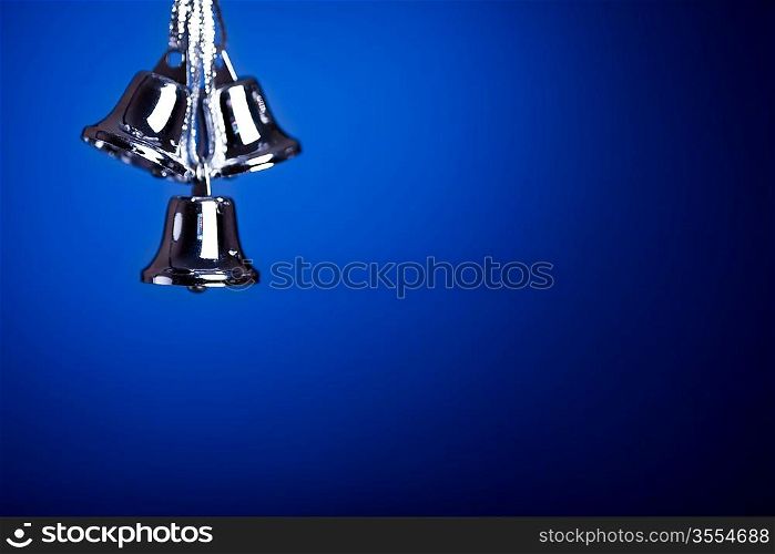 Silver Christmas tree decoration against dark blue background