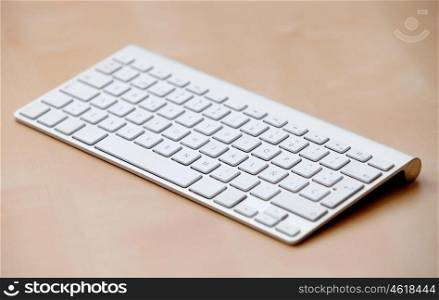 Silver computer keyboard over wooden surface