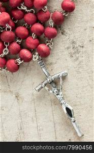 Silver cross crucifix on old canvas background