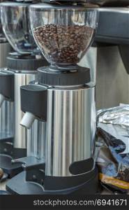Silver Electric Coffee Grinder with Brown Coffee Beans. Silver Electric Coffee Grinder with Coffee Beans
