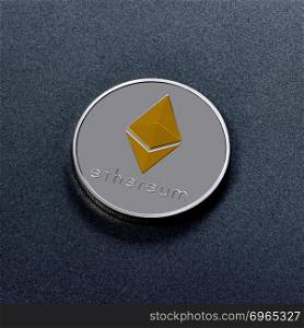 Silver Ethereum coin with a golden symbol represented on a dark background. Conceptual image for worldwide cryptocurrency and digital payment system. Top view. One silver coin is ethereum on a black background. Worldwide Crypto-Currency